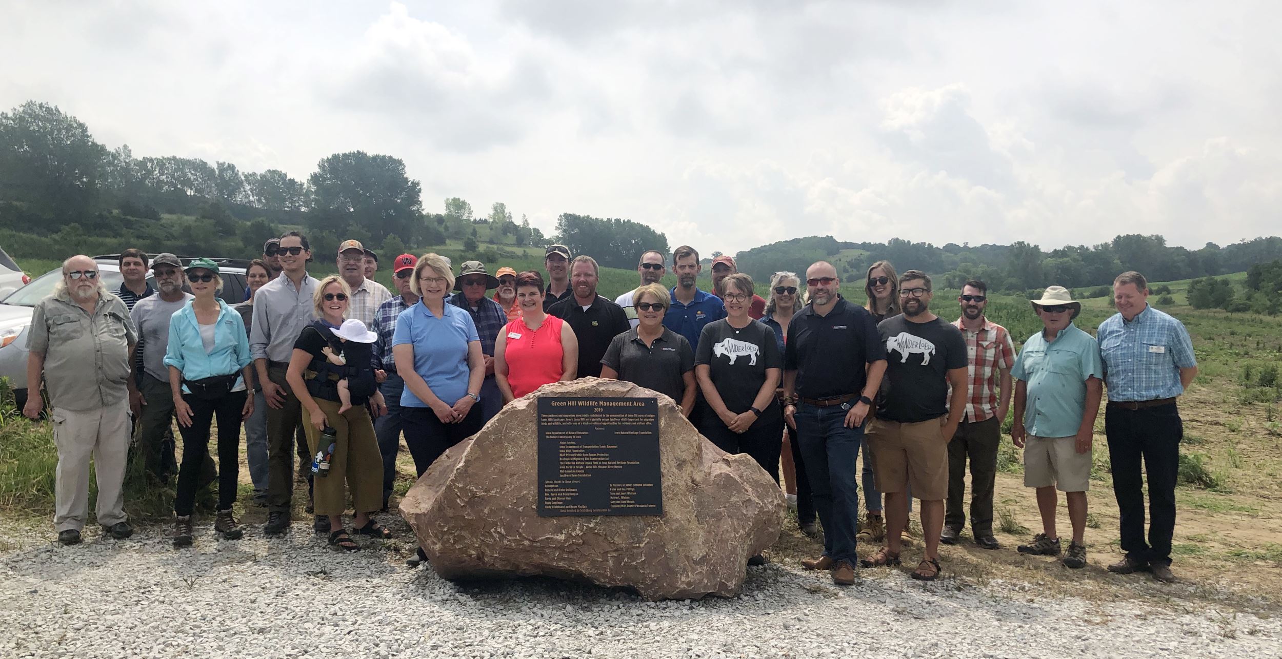 Group of people around the dedication rock