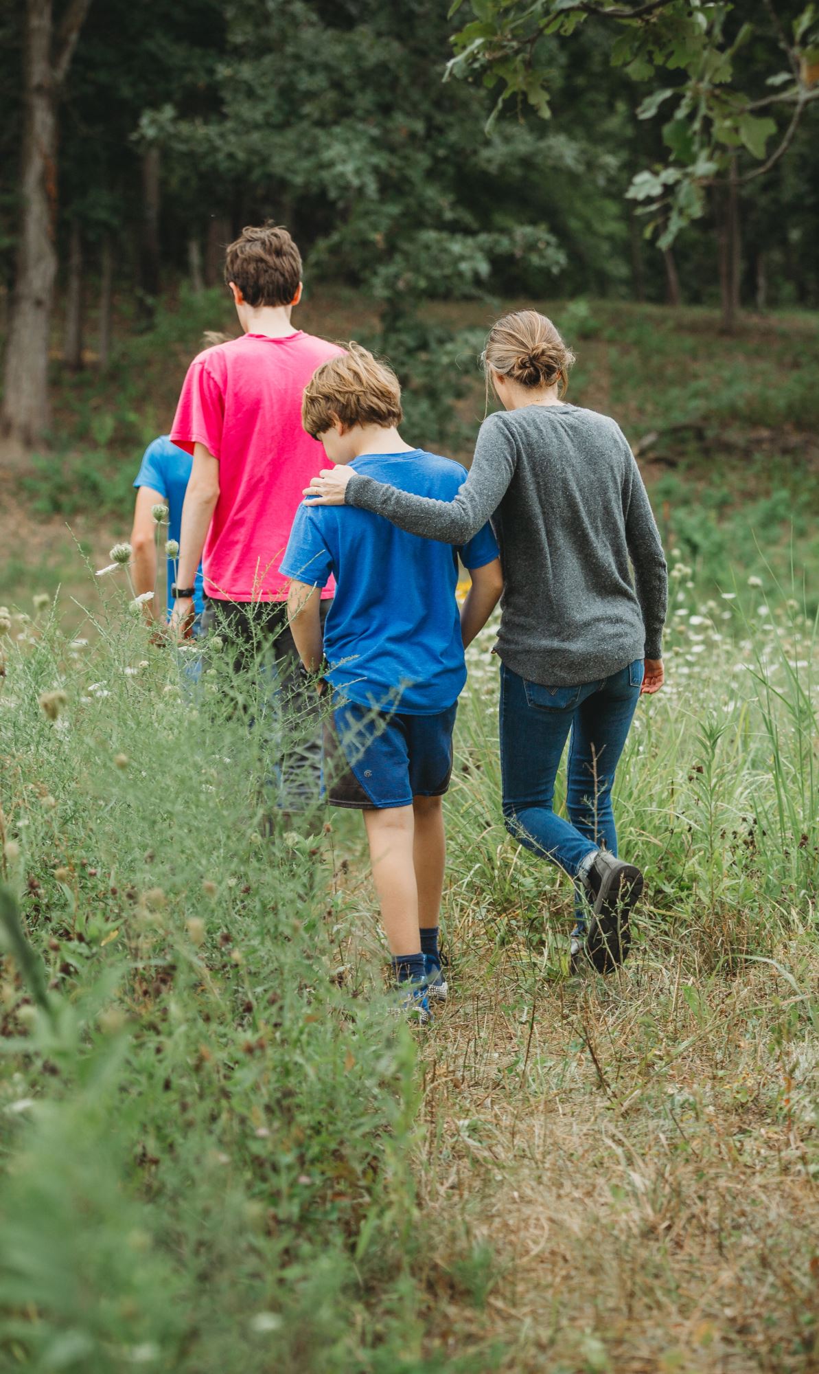 A family walks through a woodland