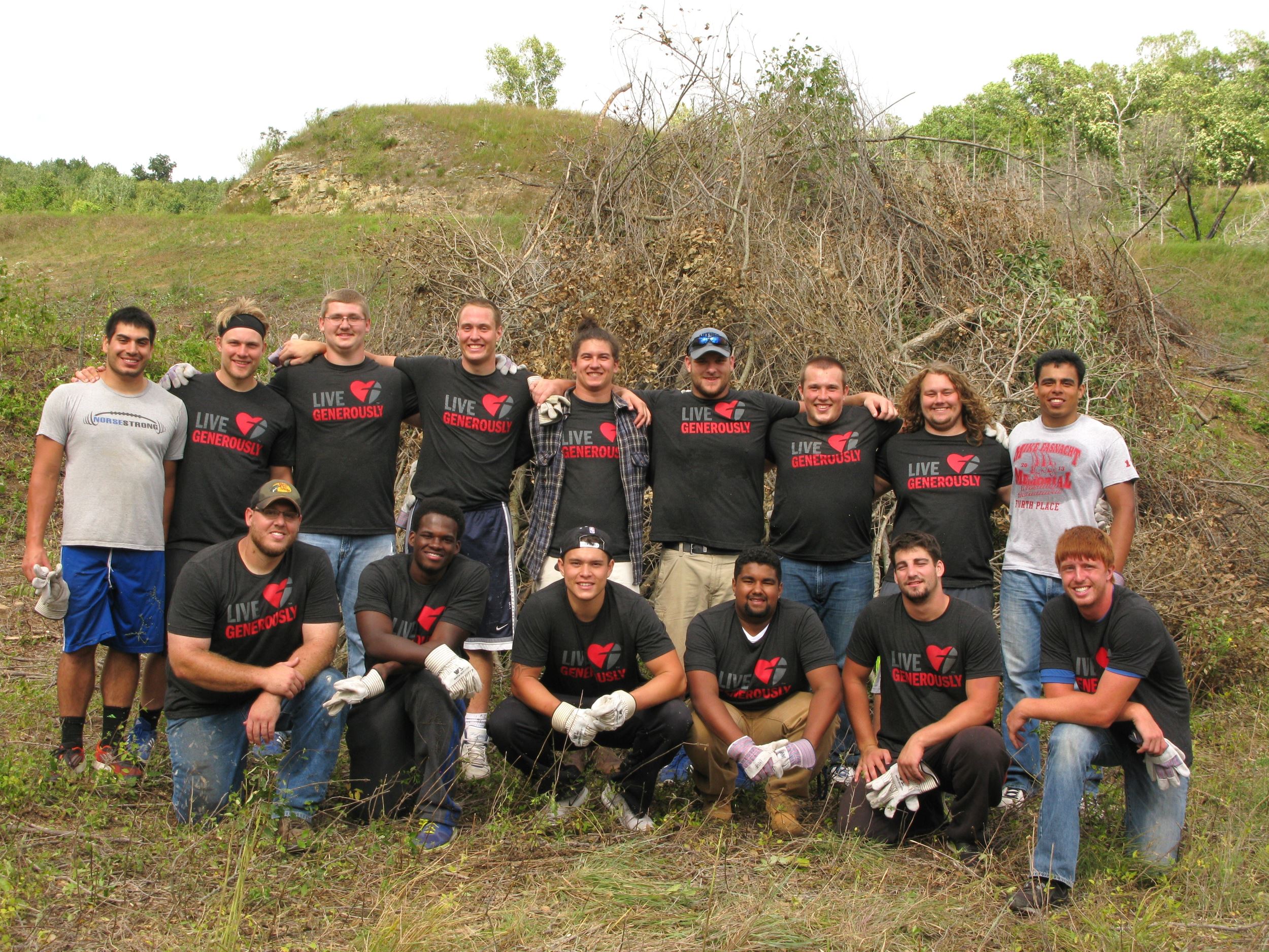 Luther football team volunteering with INHF