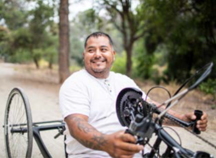 guy on hand crank bike