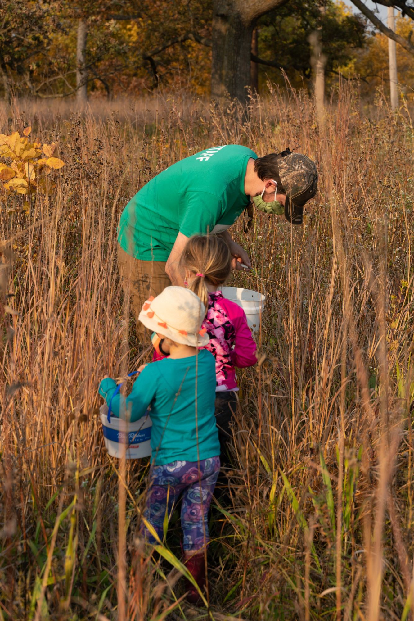 A family collects prairie seeds. 