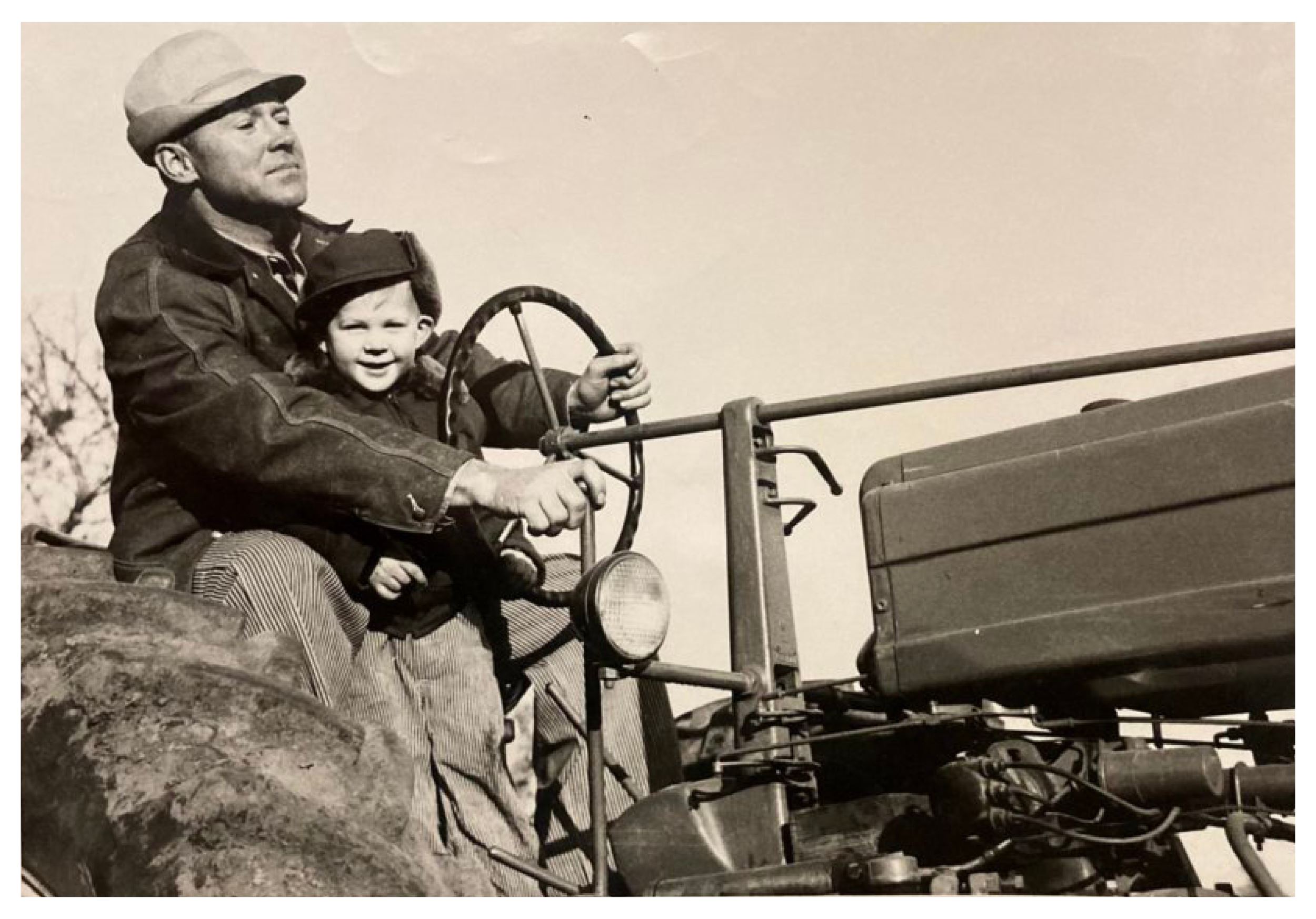 Carl with his father, Don, on a tractor on the farm.
