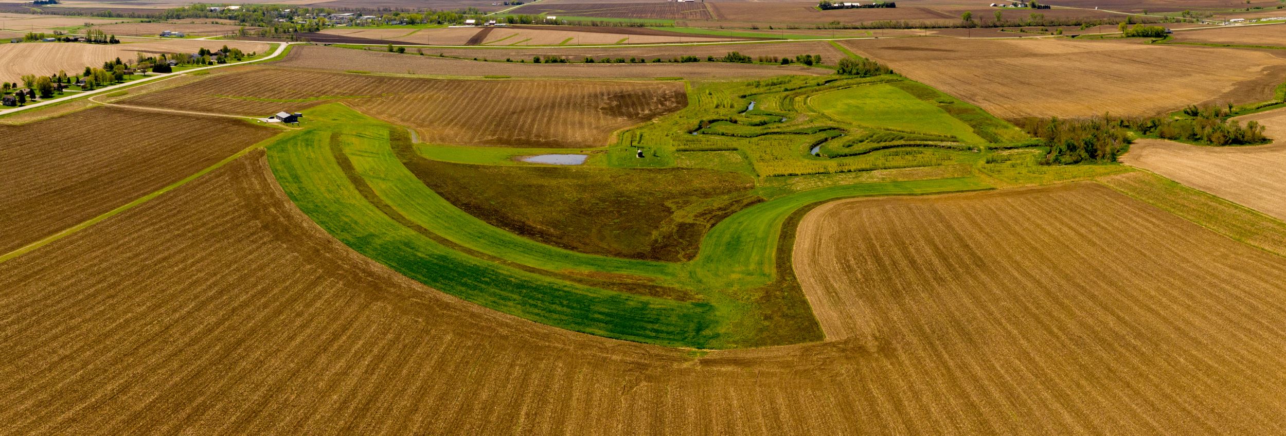 Aerial view of Lark fields, a green island between farm fields.